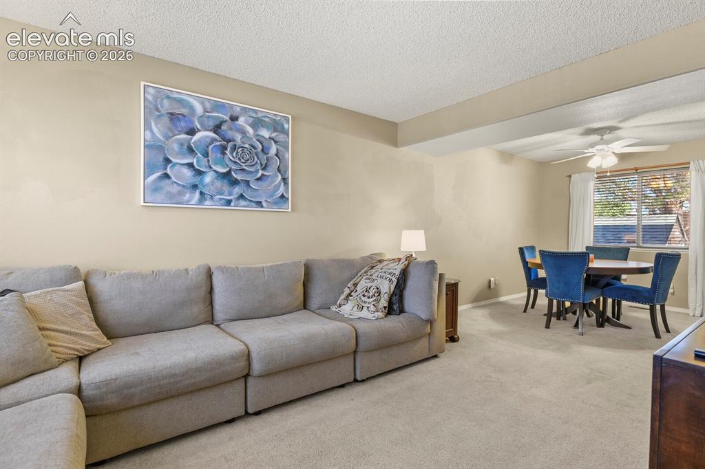 Image 14 of 44: Living room from the door off the front entrance, looking into connected di