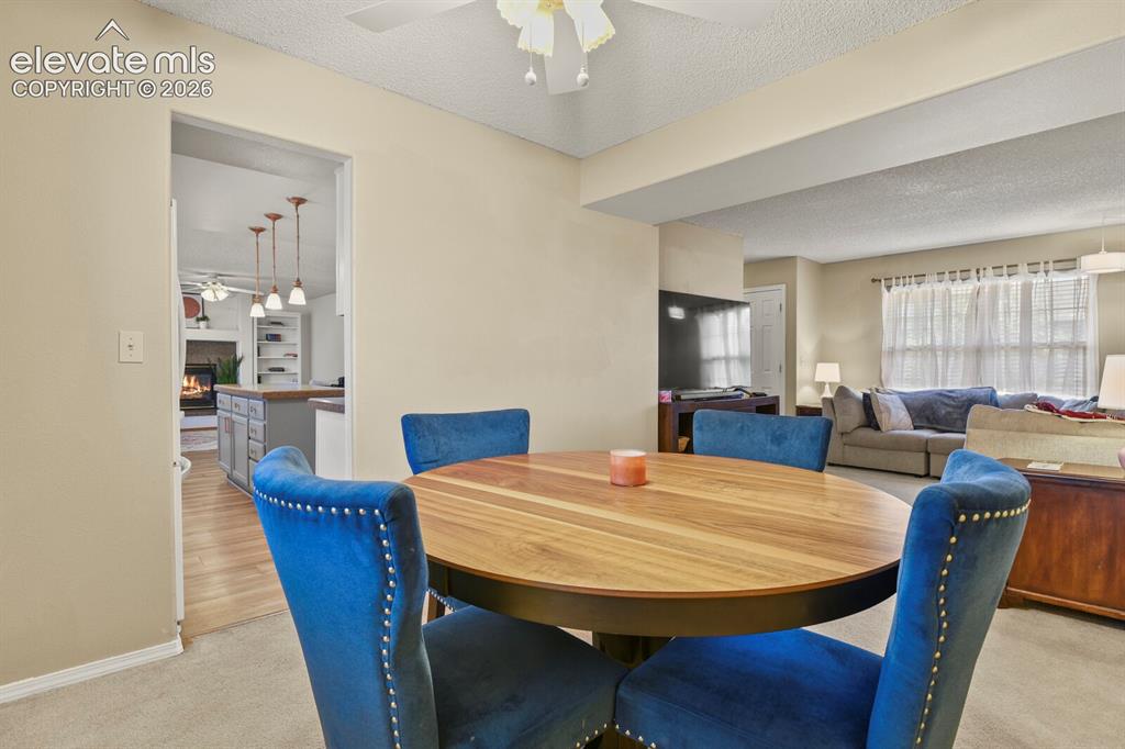 Image 17 of 44: Dining Area looking towards Living Room and through door to the kitchen.