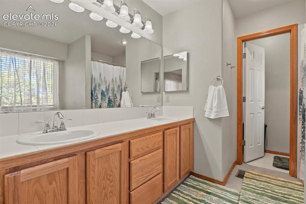 Image 21 of 44: Double sink in bathroom attached to the Primary Bedroom.