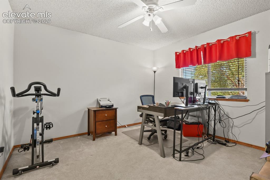 Image 28 of 44: 3rd secondary upstairs bedroom, currently being used as a home office.