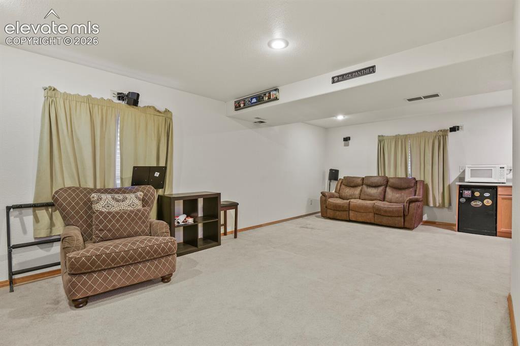 Image 30 of 44: Downstairs Living Room, looking from bottom the staircase.