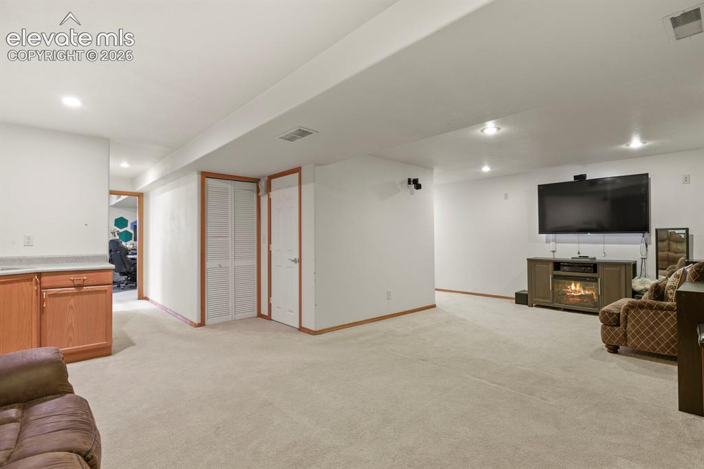 Image 31 of 44: Downstairs Living Room looking towards the downstairs bedroom and the entra