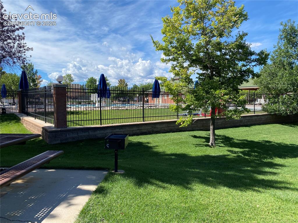 Image 42 of 44: Looking towards the fenced in pool from one of the picnic areas.