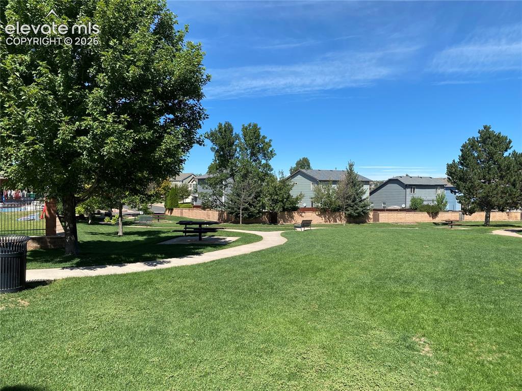Image 44 of 44: Wider view of the grassy lawn, some picnic areas, walking paths, benches.  