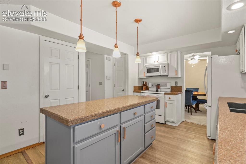 Image 9 of 44: Kitchen looking towards entrance to dining room (right), hallway to front d