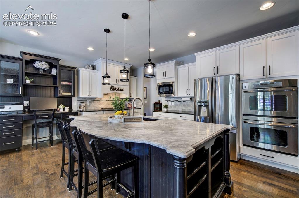 Image 2 of 44: Gourmet kitchen with double ovens