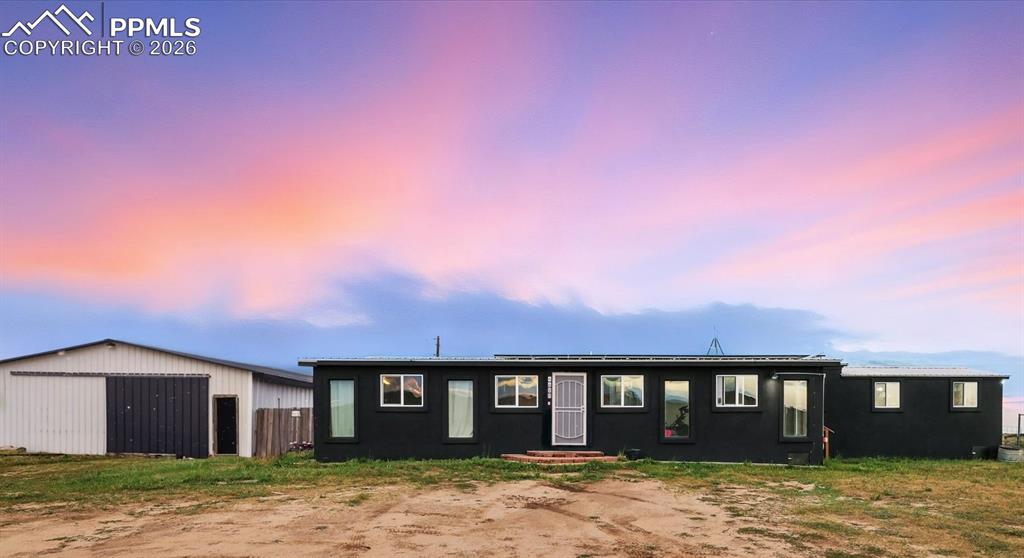 Image 1 of 47: Ranch-style house with an outbuilding, a detached garage, and a pole buildi
