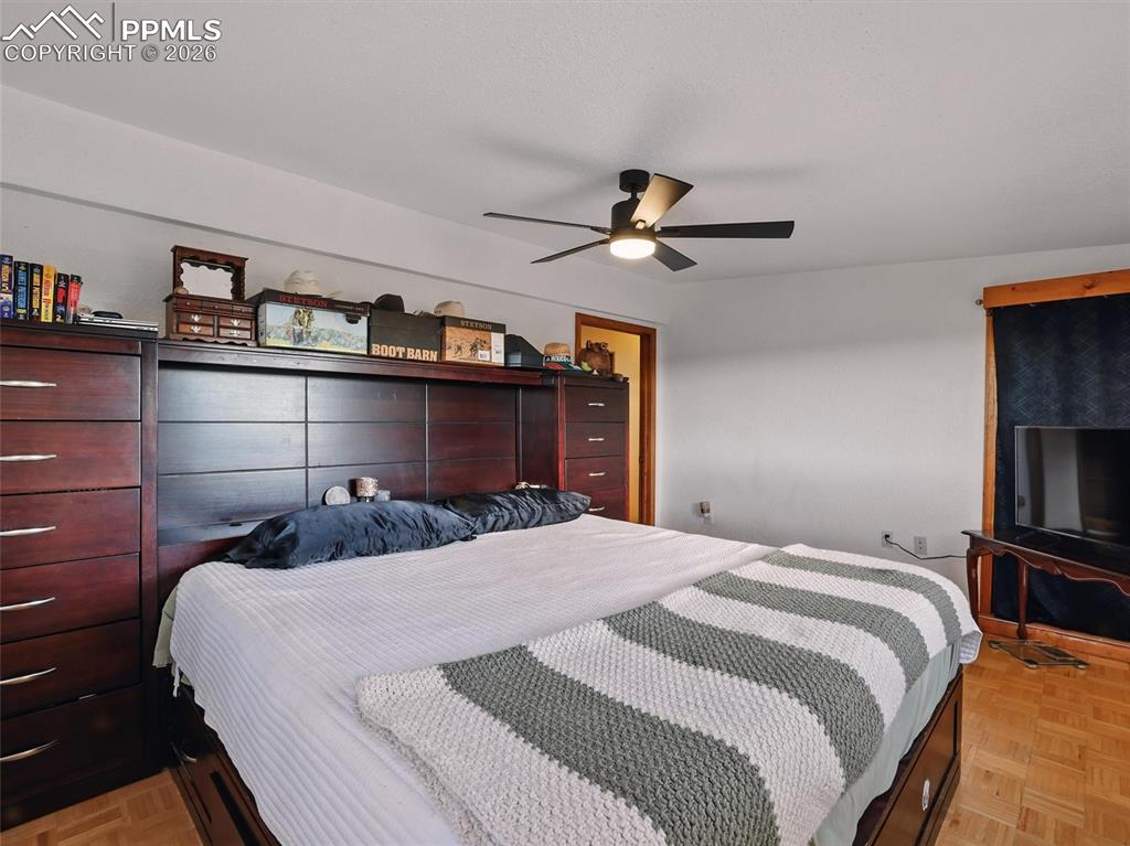 Image 24 of 47: Bedroom featuring parquet flooring and ceiling fan