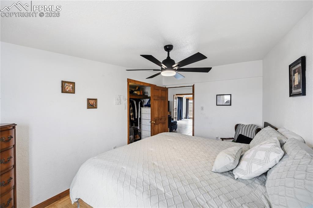 Image 29 of 47: Bedroom featuring light wood finished floors and ceiling fan