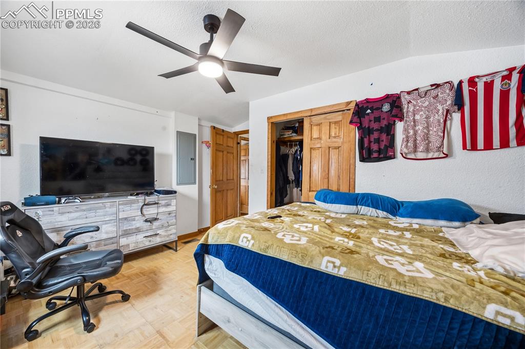 Image 31 of 47: Bedroom featuring a closet, parquet floors, a ceiling fan, and electric pan