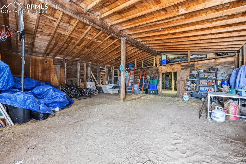 Image 38 of 47: Miscellaneous room with lofted ceiling