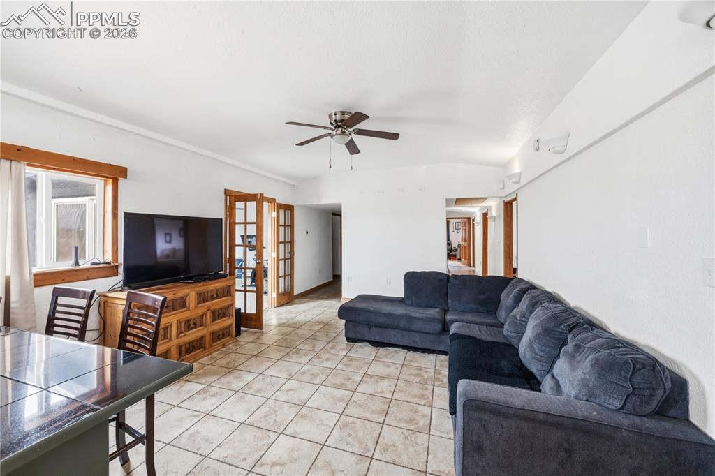 Image 5 of 47: Living area featuring a ceiling fan and light tile patterned floors