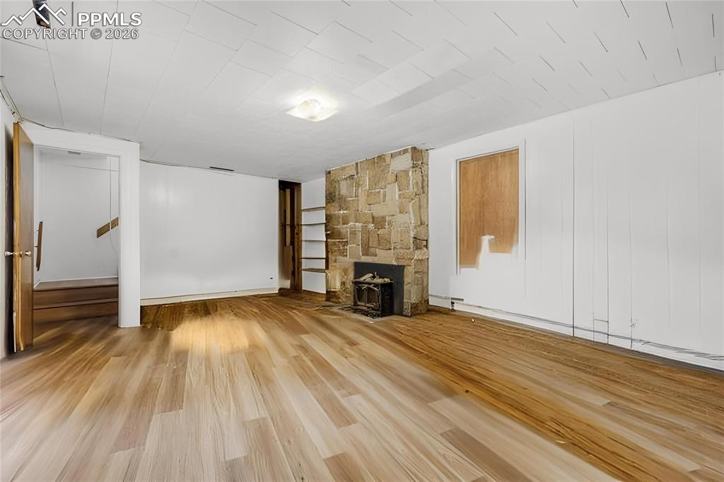 Image 12 of 29: Kitchen featuring wood-finish flooring, white cabinetry, butcher block coun