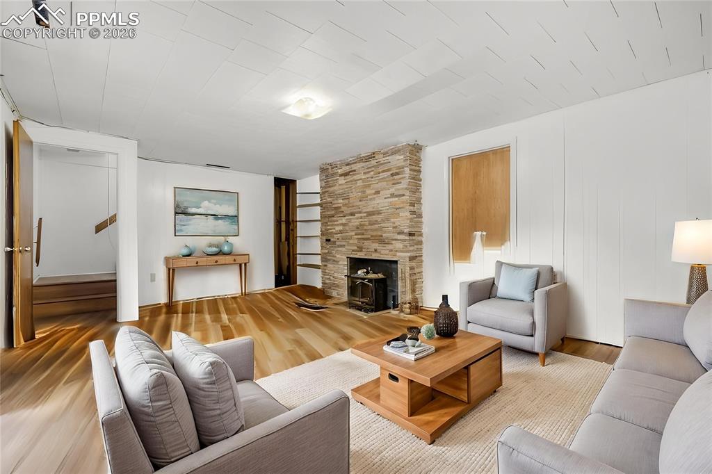 Image 13 of 29: Virtually Staged 
Kitchen featuring wood-finish flooring, white cabinetry,