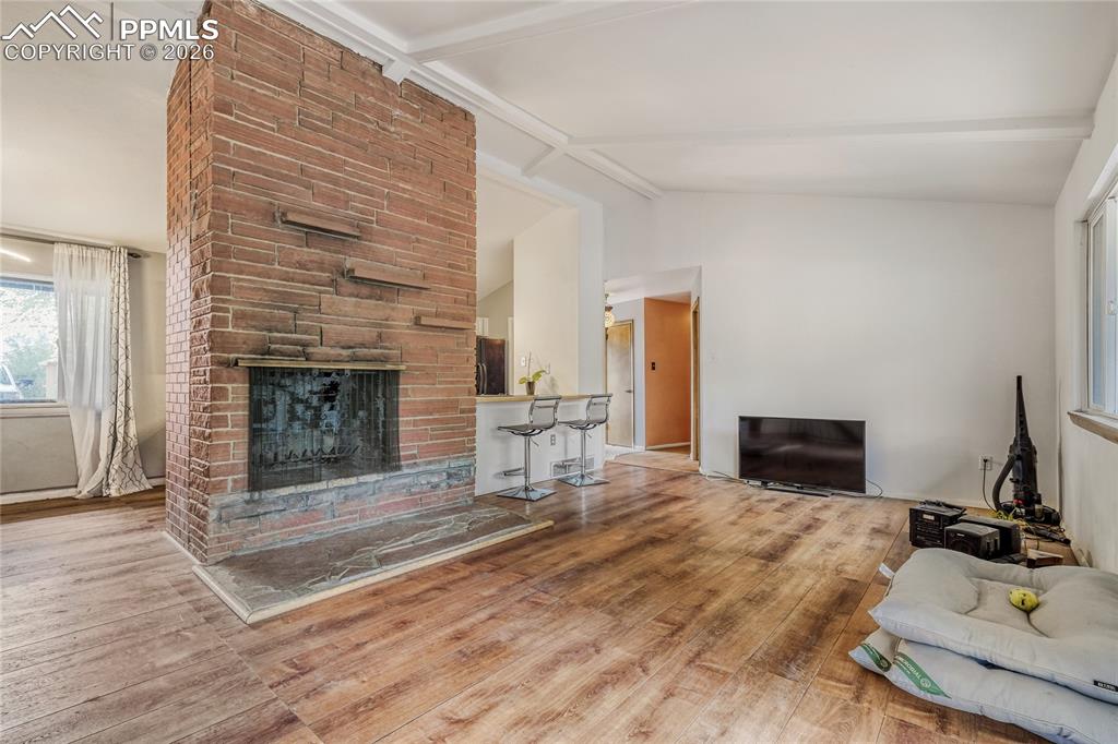 Image 14 of 29: Hardwood flooring throughout this room, featuring two windows and a ceiling
