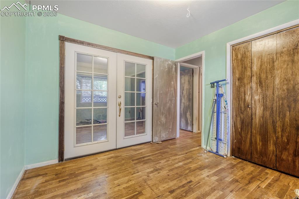 Image 16 of 29: Expansive room featuring wood-finish flooring, a stone-clad fireplace with 