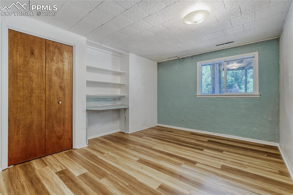 Image 19 of 29: Interior space featuring wood-finish flooring, a double-pane window, and a 
