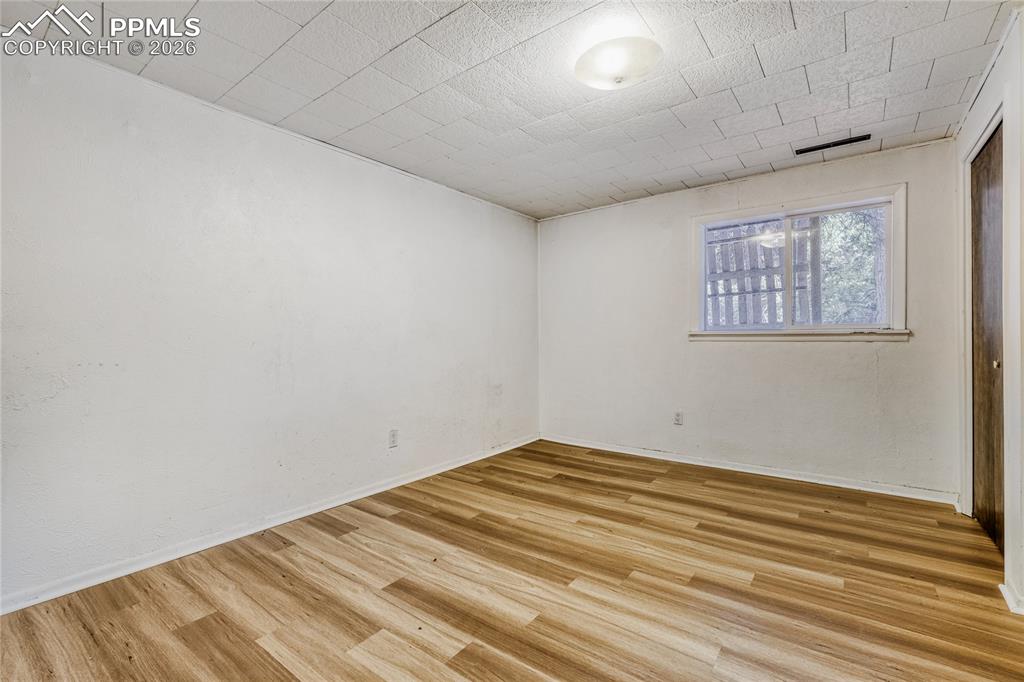 Image 21 of 29: Kitchen featuring wood-finish flooring, white cabinetry, and wood counterto