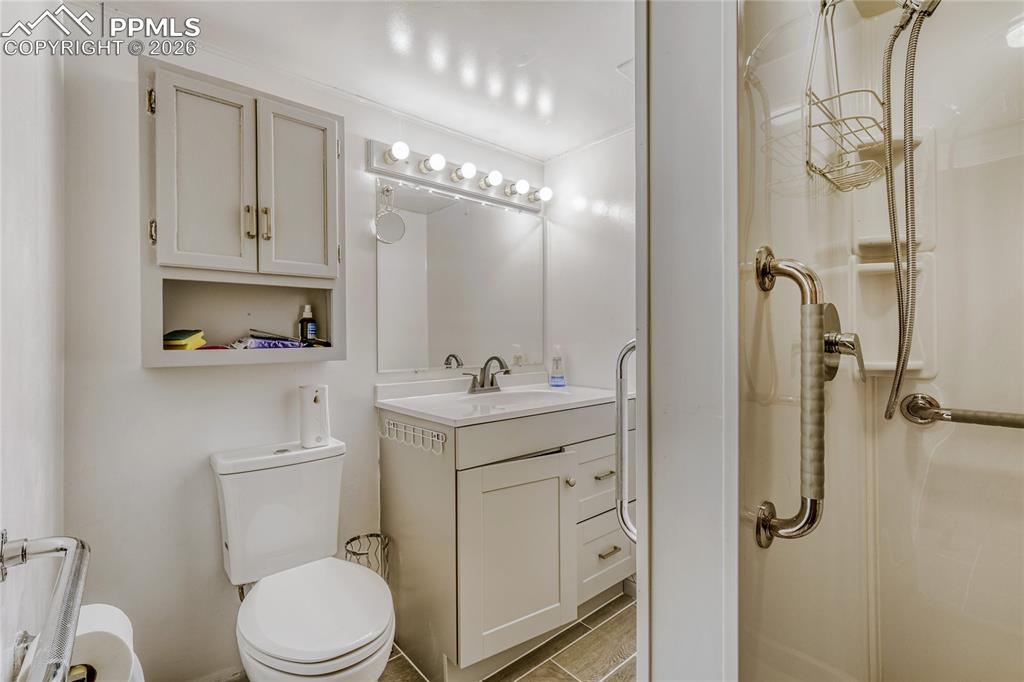 Image 23 of 29: Room featuring wood-finish flooring, a built-in closet with natural wood bi