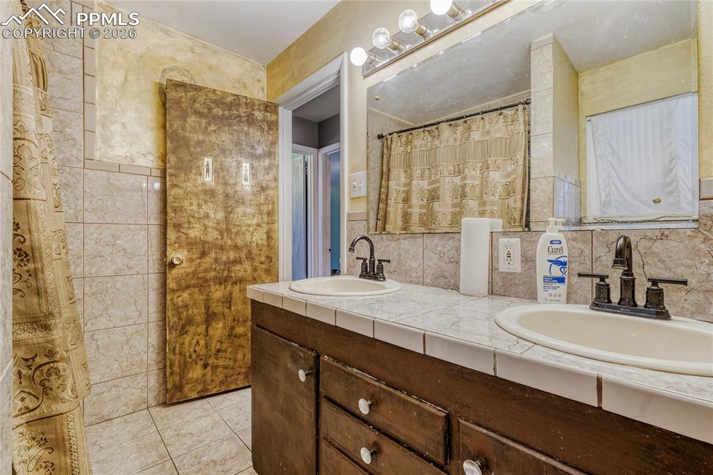 Image 25 of 29: Room featuring wood-finish flooring, white painted walls, a window with ext