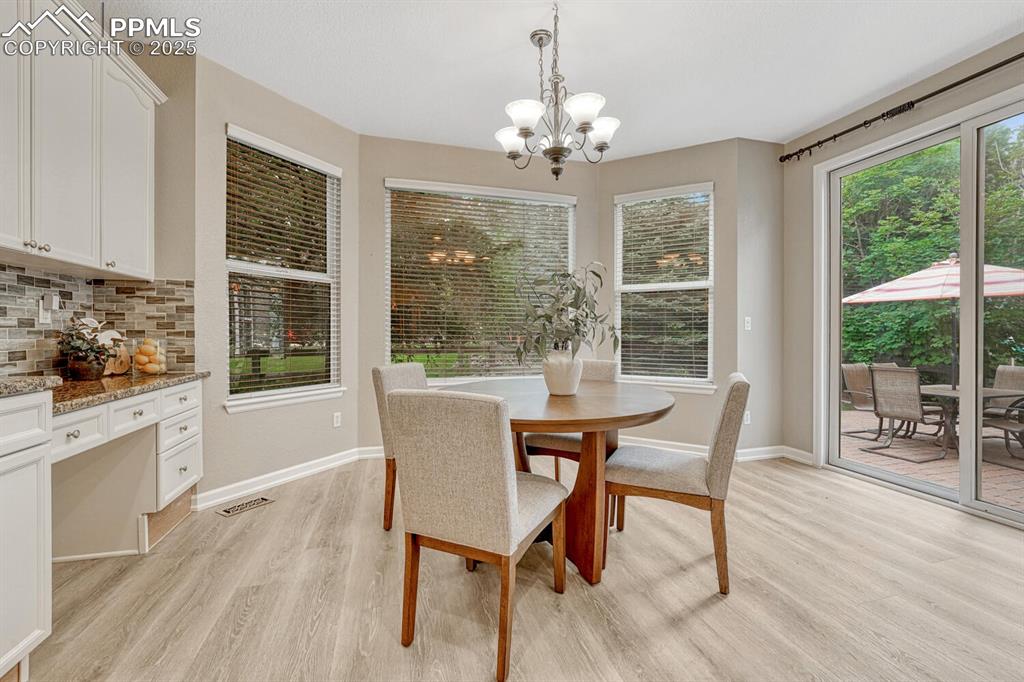 Image 14 of 50: Dining area featuring light wood-style floors and a chandelier