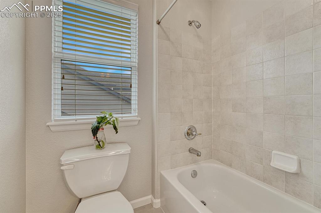 Image 30 of 50: Bathroom featuring toilet and washtub / shower combination