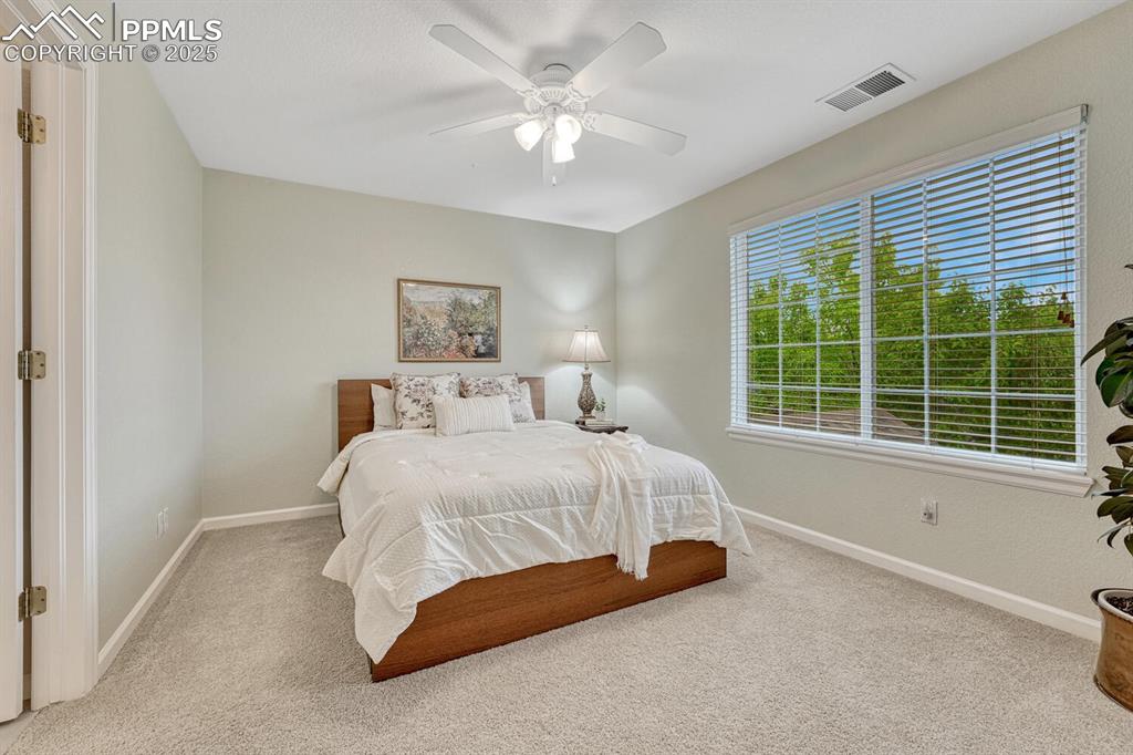 Image 31 of 50: Bedroom featuring carpet floors and a ceiling fan