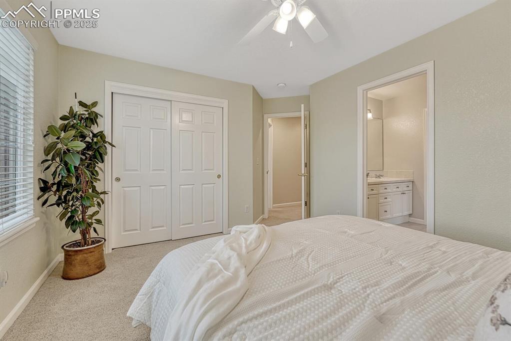 Image 32 of 50: Bedroom featuring a closet, carpet floors, and ceiling fan