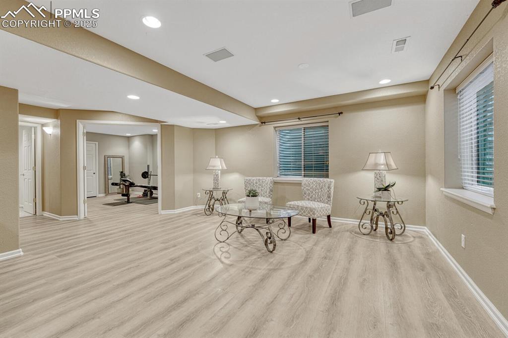 Image 36 of 50: Sitting room with light wood-type flooring and recessed lighting