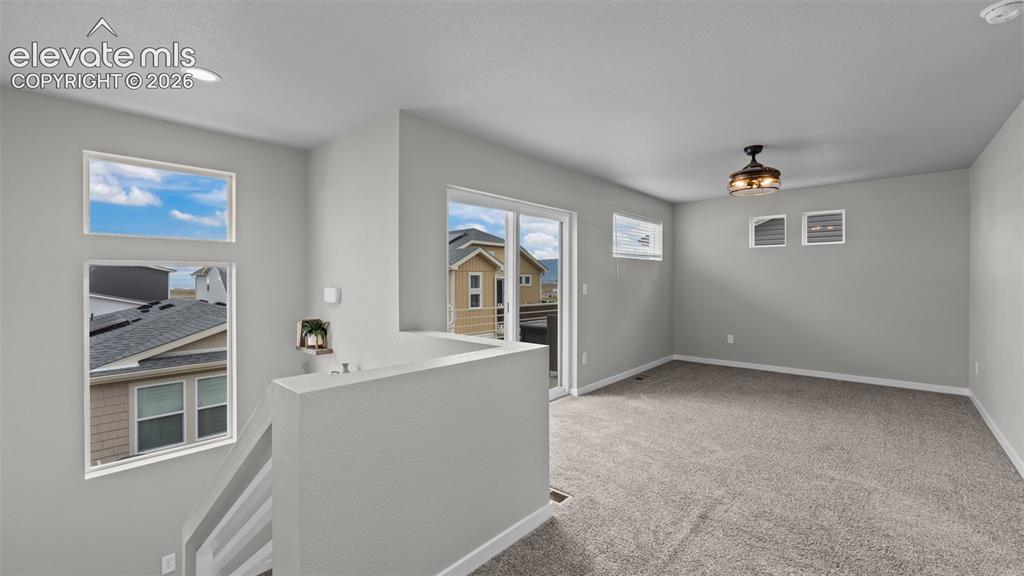 Image 19 of 34: Open floor area featuring wall-to-wall carpeting, recessed ceiling lighting