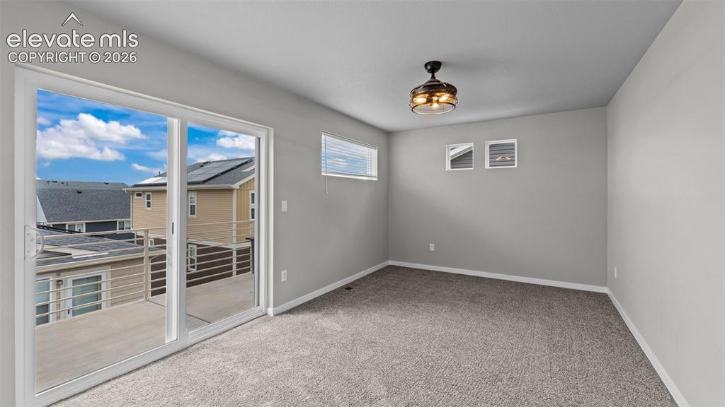 Image 20 of 34: Room featuring carpeting, sliding glass doors to a balcony, high-placed win