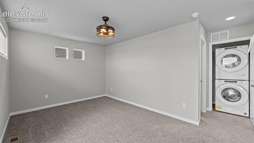 Image 21 of 34: Neutral-toned carpeting, high-positioned rectangular windows, flush-mount l