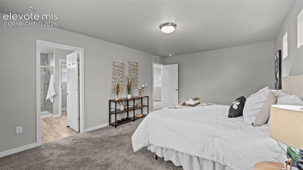 Image 25 of 34: Room featuring neutral-toned carpeting, flush-mount lighting, and solid-cor
