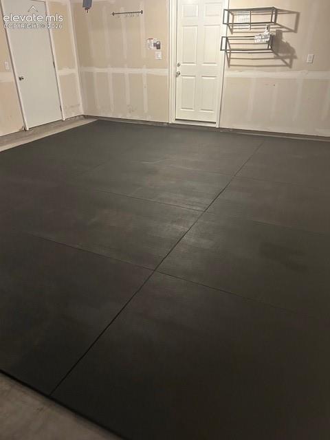 Image 31 of 34: Insulated garage interior featuring dual six-panel doors, wall-mounted meta