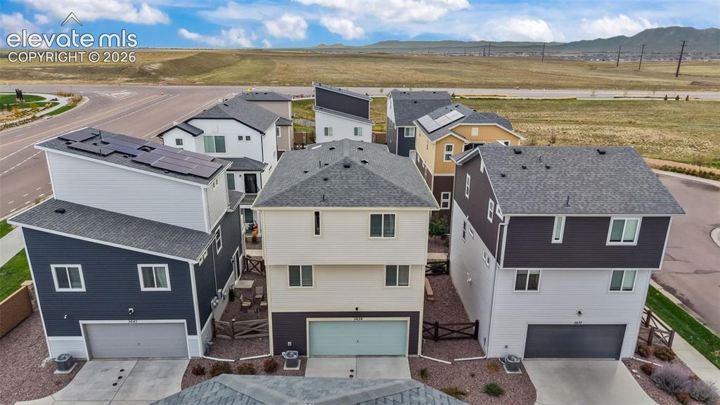 Image 32 of 34: Multi-level residential structures featuring mixed-material siding, asphalt