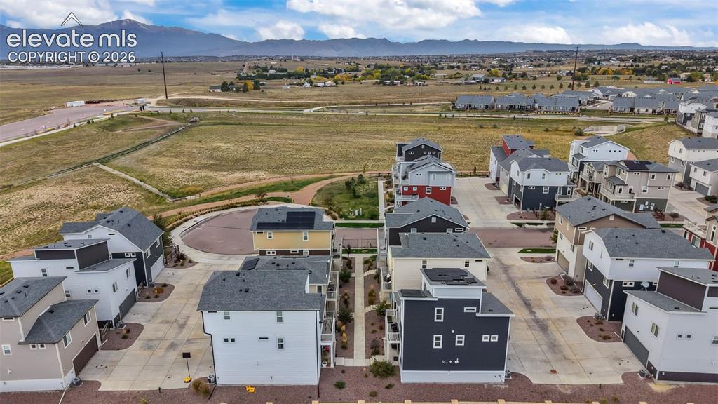 Image 34 of 34: Aerial perspective of a multi-structure property featuring high-contrast ar