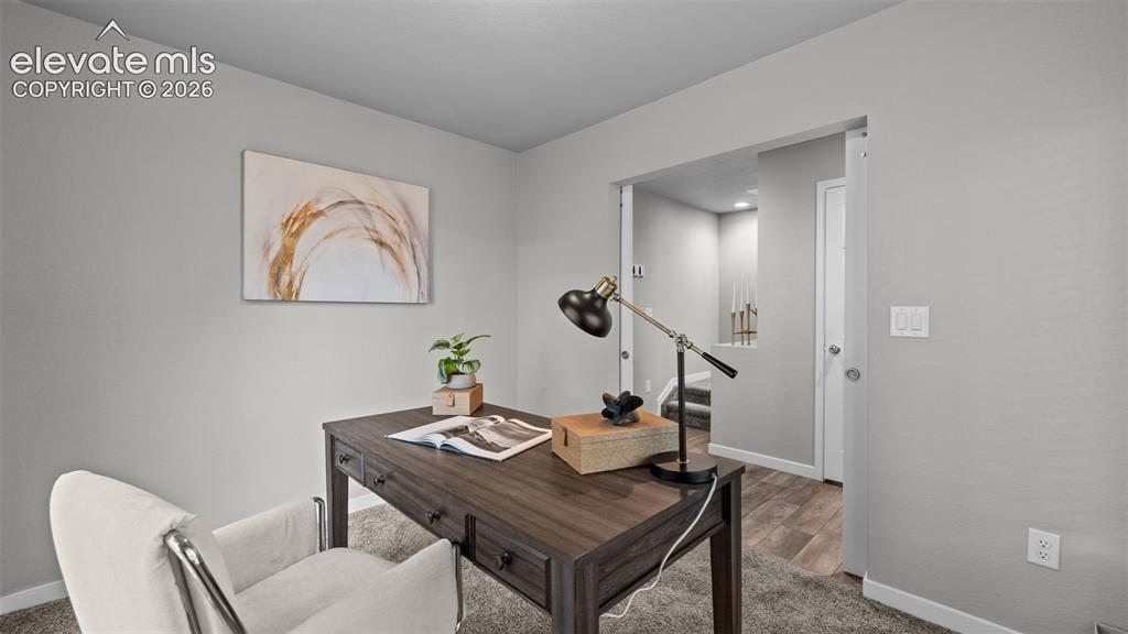 Image 4 of 34: Neutral-toned interior space featuring carpeting, smooth-finish walls, and