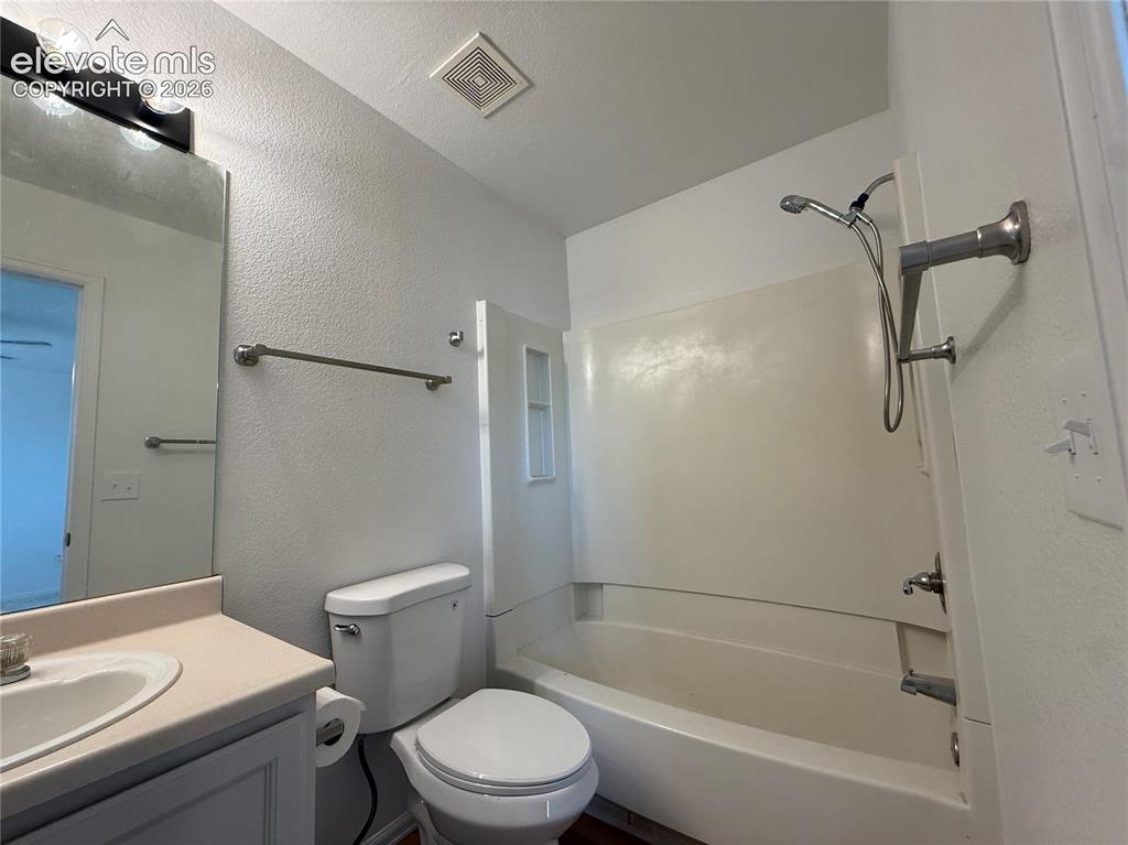Image 14 of 20: Bathroom featuring a combined tub and shower unit, a vanity with an integra