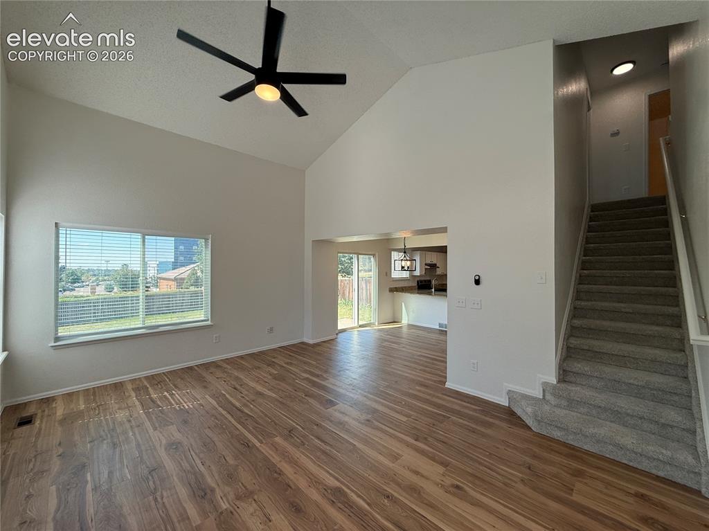 Image 8 of 20: Vaulted great room featuring wood-finish flooring, a contemporary ceiling f