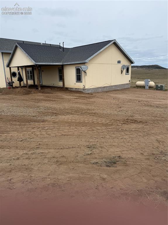 Image 19 of 19: Exterior siding with a covered porch entry