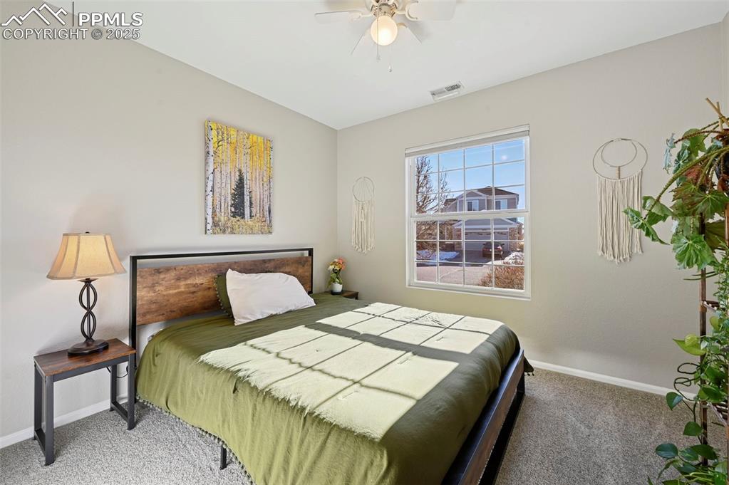 Image 13 of 24: Carpeted bedroom with baseboards and ceiling fan