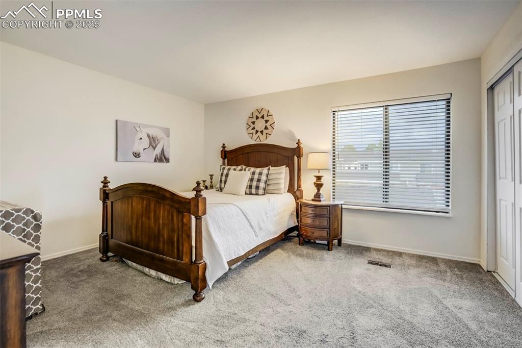 Image 15 of 31: Bedroom with carpet flooring and a closet