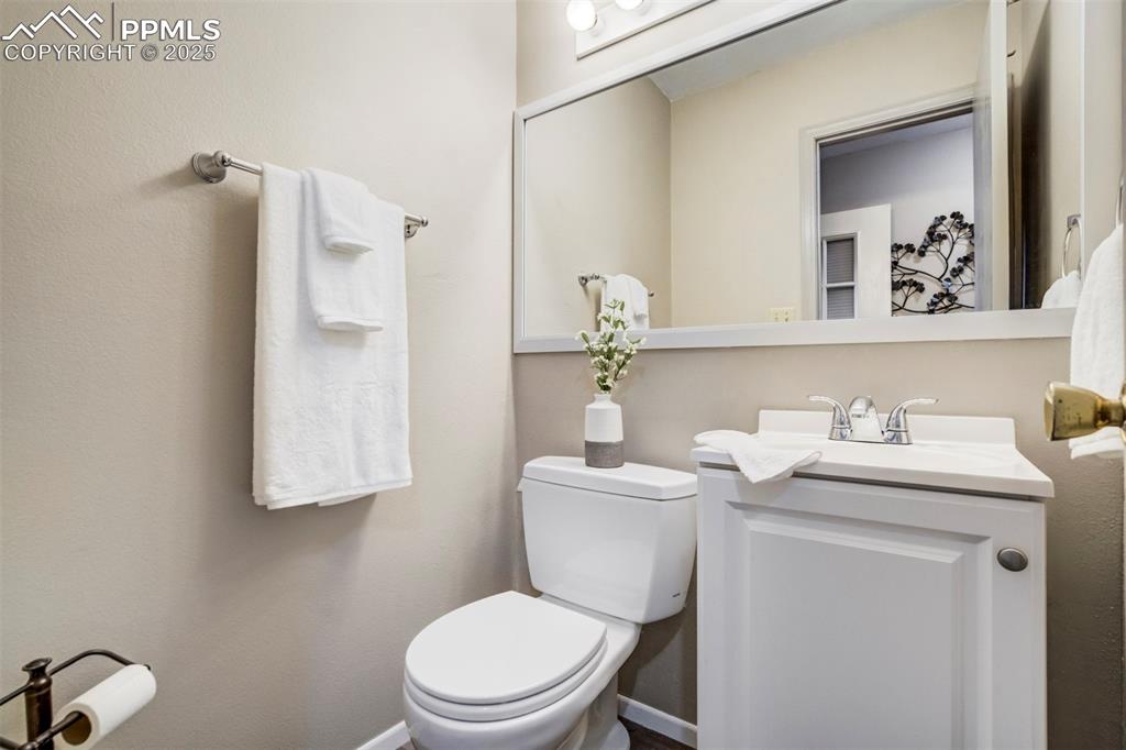 Image 17 of 31: Half bathroom featuring toilet and vanity