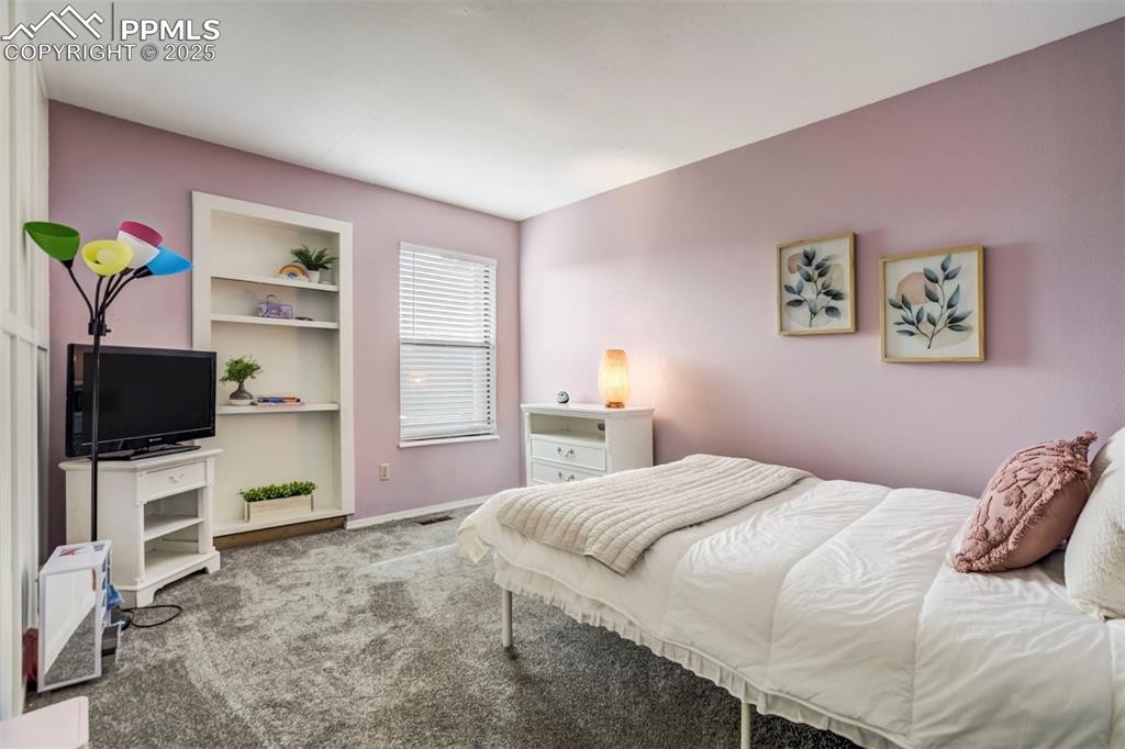 Image 18 of 31: Carpeted bedroom with baseboards