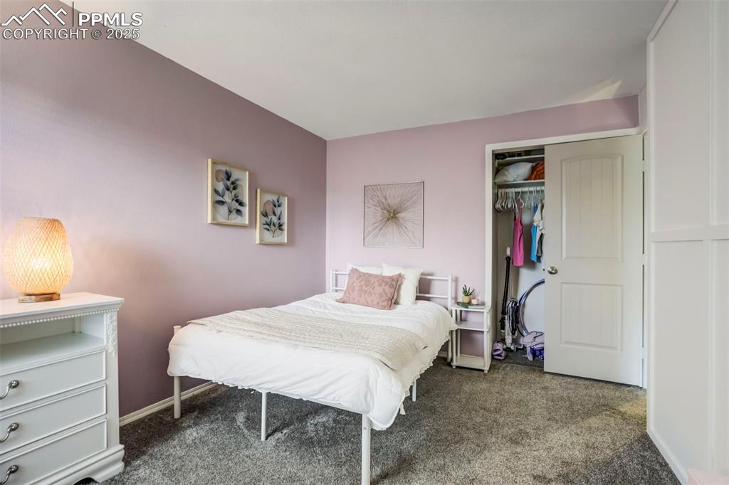 Image 19 of 31: Bedroom with dark carpet and a closet
