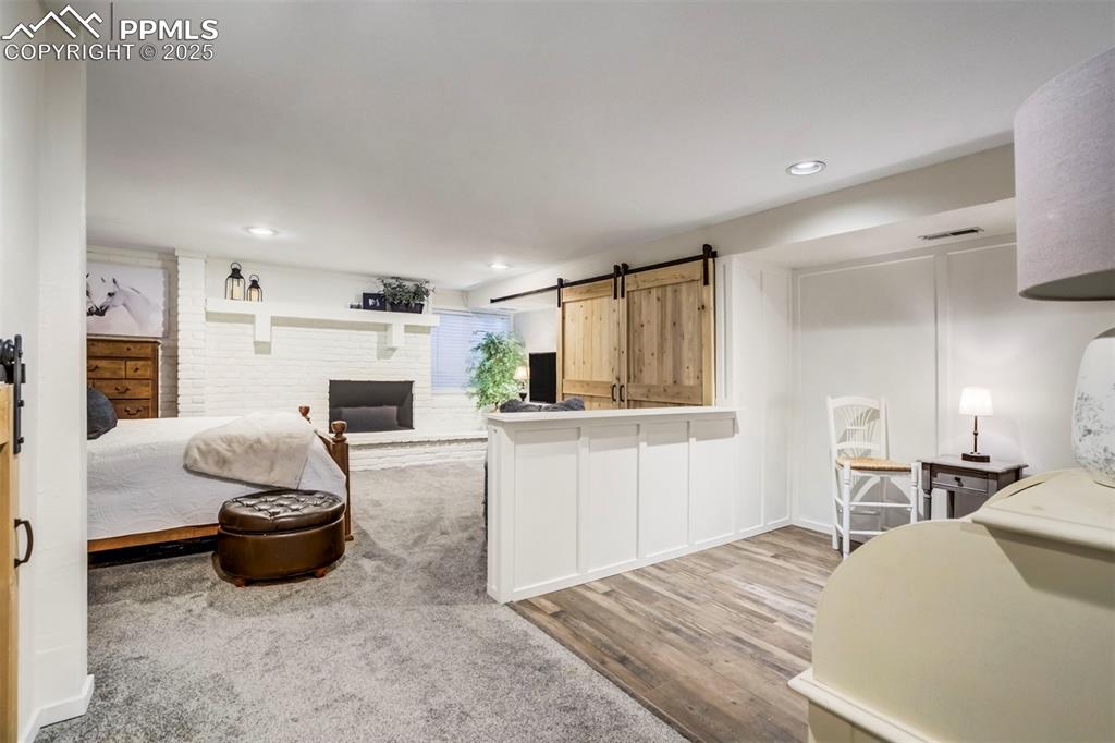 Image 21 of 31: Kitchen featuring a barn door, light countertops, light wood-style flooring