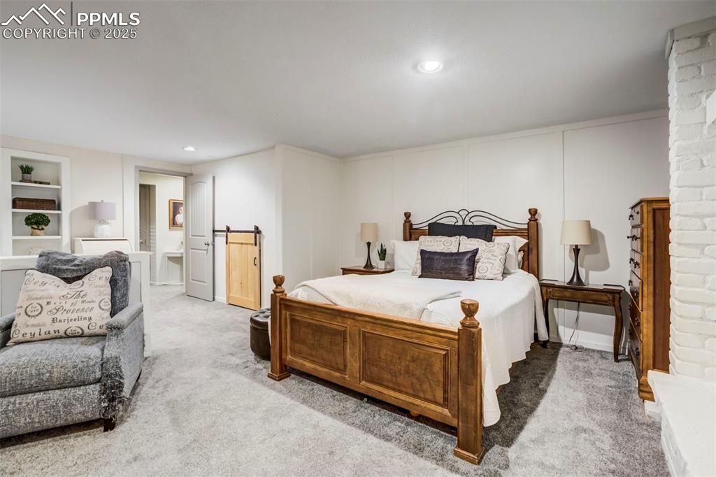 Image 23 of 31: Carpeted bedroom featuring recessed lighting and a decorative wall