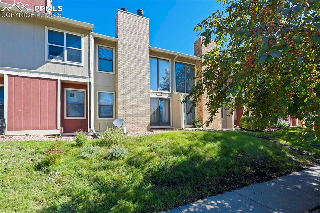 Image 6 of 31: Back of property with a chimney and a yard