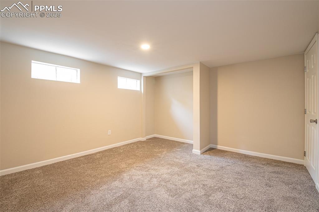 Image 21 of 35: Below grade area with carpet floors and baseboards