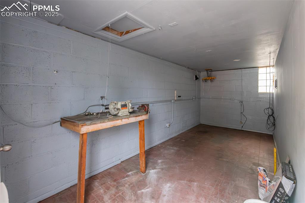 Image 35 of 35: Basement featuring concrete block wall